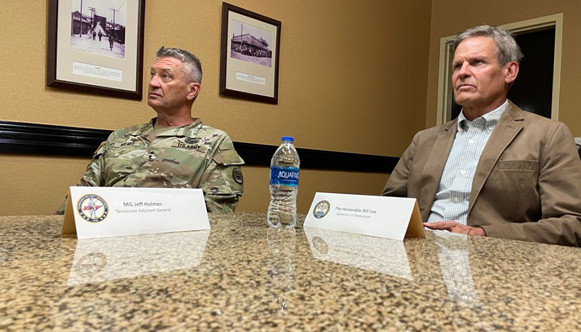 Gov. Bill Lee, on the right, sitting down in a room. Lee recently visited the southern border
