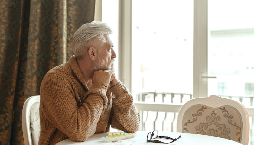 Man looking out window