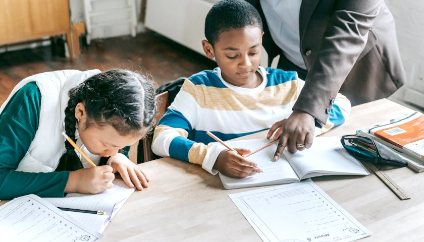 Tutor helping kids study